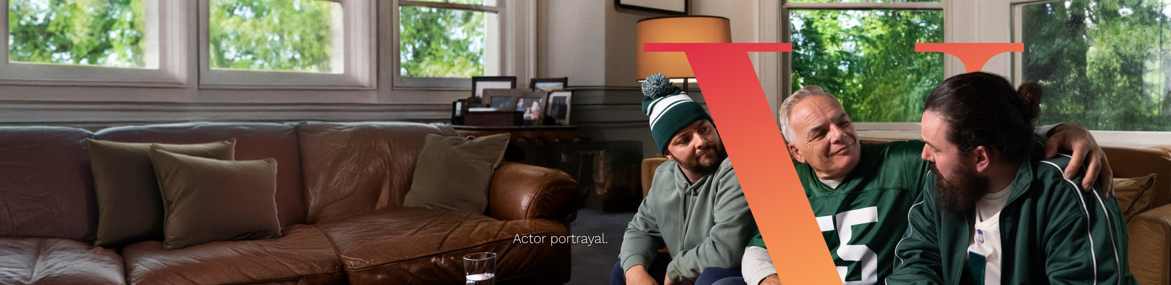 Father and two sons sitting on a couch together, with PLUVICTO V