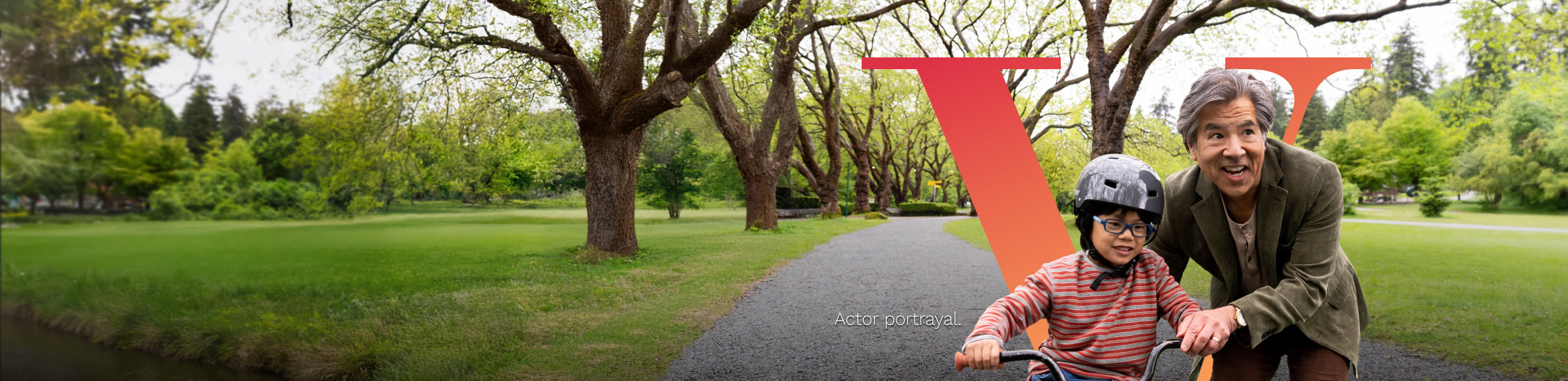 Man teaching his grandson how to ride a bike, in front of Pluvicto V.