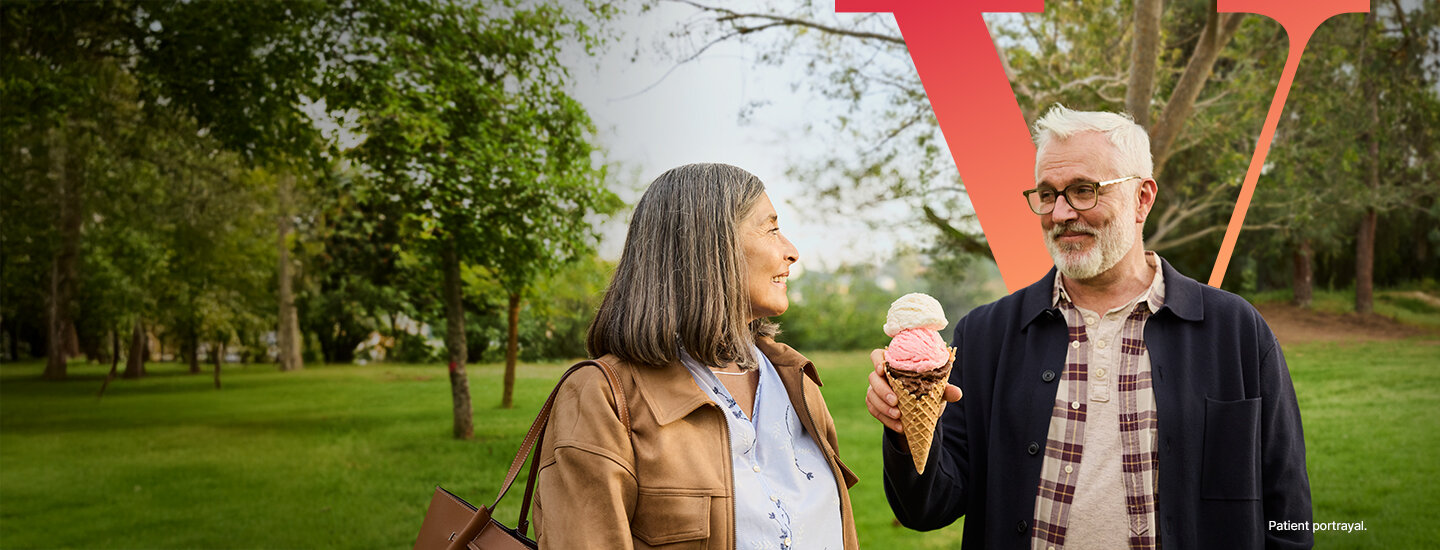 Two people holding an ice cream cone