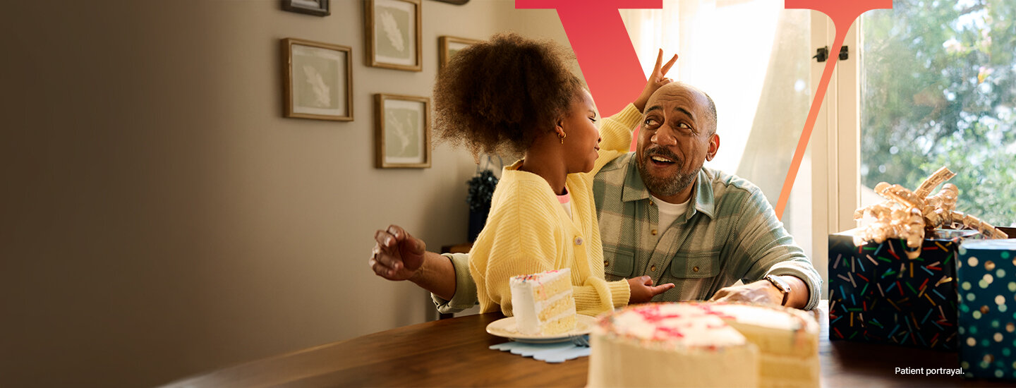 Man with his granddaughter and a birthday cake