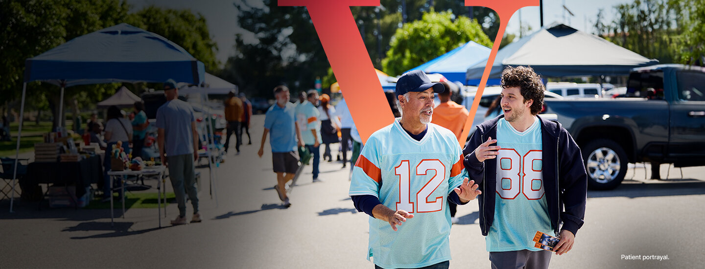 Father and son walking at a tailgate