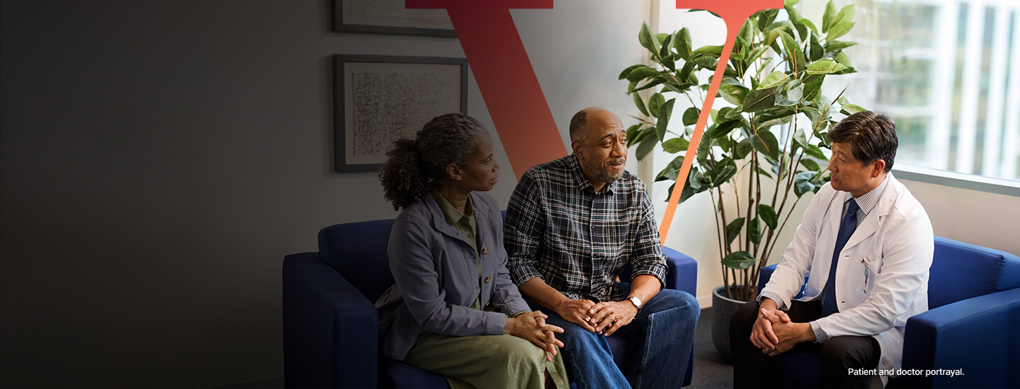 Two people talking to a doctor